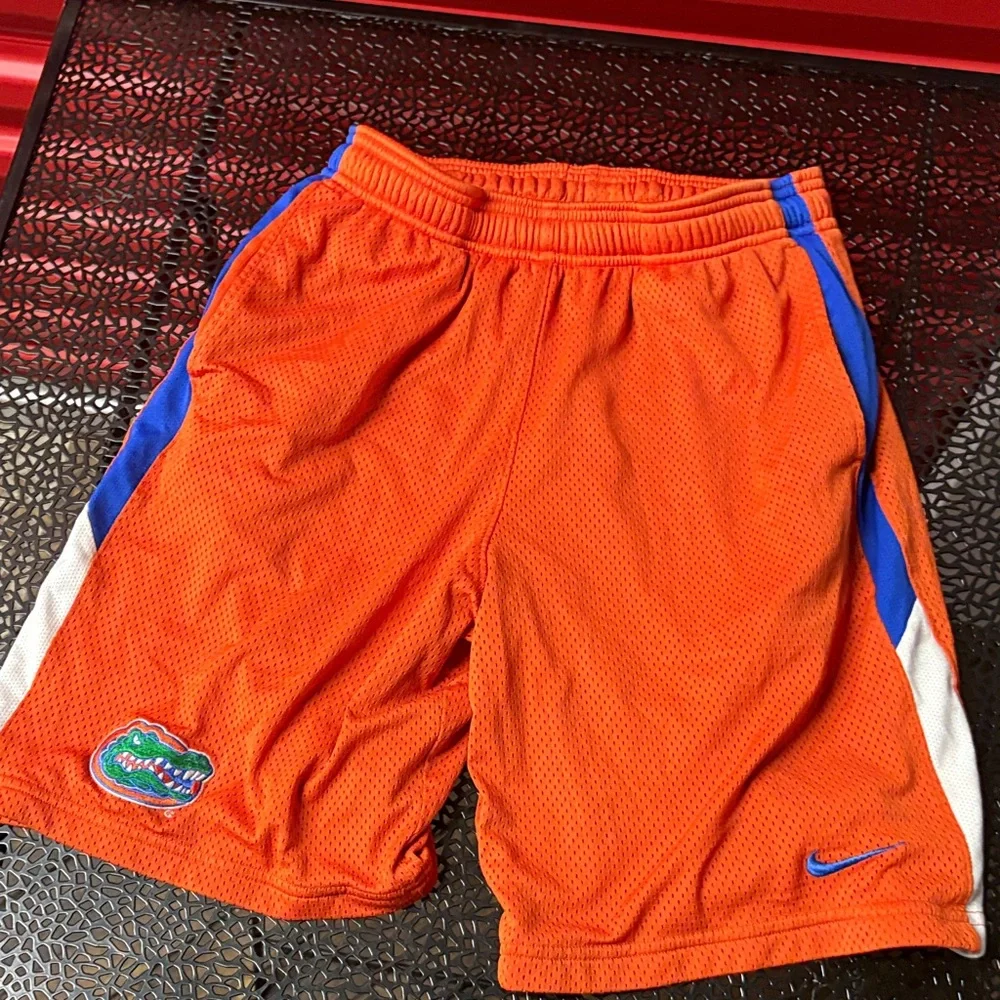 Nike Orange Athletic Shorts with Blue and White Accents size small patch logo